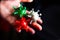 Woman holds in her hand coronavirus models in white, green and red colors.