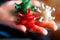 Woman holds in her hand coronavirus models in white, green and red colors.