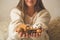 A woman holds in her hands a beautiful fall assortment. Cotton, bump, nut and acorn.