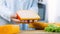 The woman holds in her hands a piece of cheese with holes. Slider filmed cheese presentation process