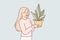 Woman holds houseplant in pot, wishing to decorate interior with plant that absorbs carbon dioxide