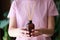 Woman holds jar with an aromatic diffuser of homemade fragrance in hands