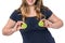 Woman holds kiwi above her breast - plastic surgery concept