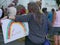 Woman holds `LOVE` rainbow sign at political rally