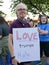 Woman holds `LOVE trumps hate` sign at political rally