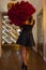 Woman holds luxury bouquet of red roses.
