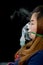 Woman holds mask inhaler treatment of asthma