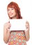 Woman holds plate and her face is semi profile. Redhead girl wears colorful and cheerful dress. Summer..