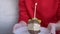 A Woman Holds a Plate with a Piece of Birthday Cake and One Lighted Candle. 4K