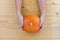Woman holds a pumpkin. Female hands with trendy autumn marble manicure in orange color. copy space for your text