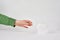 Woman holds a roll of tissue in hands on a white background. Concept of Covid-19 quarantine.Doomsday panic people panic