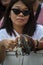 Woman holds rosaries in her hand to be blessed by Pope Francis