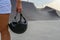 A woman holds a safety helmet after riding in an extreme park. The skate park, rollerdrome, quarter and half pipe ramps. Extreme