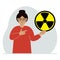 A woman holds a sign with a warning about nuclear danger. The concept of nuclear war, radiation, biohazard.