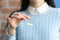 Woman holds small packet of white powder in her hands