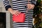 Woman holds a small stylish bag clutch of bright red color wit