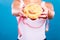 Woman holds sweet bun recommending non sugar diet