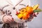 Woman holds a sweet eatable bouquet wrapped in paper on black background