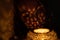 Woman holds tealight candlelight in the dark