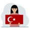A woman holds a Turkish flag in his hands. Concept for demonstration, national holiday, Turkey day or patriotism