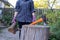 Woman holds a wood, preparing chopping firewood.