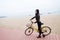 Woman On Holiday Ride on a bicycle On Winter Beach