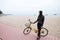 Woman On Holiday Ride on a bicycle On Winter Beach