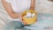 Woman in home clothes holds easter eggs in a yellow plate close-up. Female hands hold a plate with eggs. Happy easter