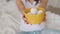 Woman in home clothes holds easter eggs in a yellow plate close-up. Female hands hold a plate with eggs. Happy easter