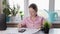 woman at home counting utility bills on a calculator, Professional woman working at her desk in a modern office