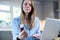 Woman At Home Looking Up Information About Medication Online Using Laptop