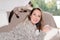 Woman at home relaxing with siamese cat