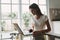 Woman at home at table in front of laptop interior