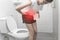 Woman at home in toilet is suffering from abdominal pain. Menstruation