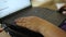 A woman at home working on a laptop. Close-up of the hand on the keyboard. The other hand moves the mouse. The concept of remote w