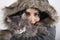 Woman In Hooded Fur Coat Holding Cat