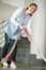 Woman hoovering floor with vacuum cleaner