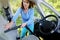 Woman hoovering a seat in car