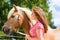 Woman with horse on pony farm