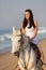 Woman horse ride beach