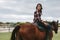 Woman horse riding inside corral ranch