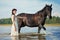 Woman on a horse by the sea