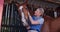 Woman, horse and stable in farm, countryside and ready in ranch for sustainable farming. Farmer, nature and outdoor