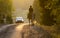 Woman horseback riding on country road