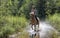 Woman horseback riding in water