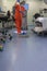 Woman from a hospital cleaning service cleaning the floors of an ophthalmic operating room