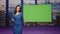 Woman host presenting newscast standing tv stage green screen. Female newsreader