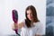 Woman with a hot straightening brush