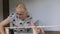 Woman housewife sitting in the room on the floor, collects wooden rack, bought in the store. Assembly of furniture.