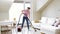 Woman or housewife with vacuum cleaner at home
